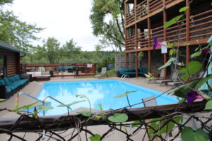 Cedar Lodge's Heated Pool: The Perfect Summer Retreat When the summer sun is shining in Wisconsin Dells, there’s no better place to relax and cool off than Cedar Lodge’s heated outdoor pool. This sparkling oasis is a favorite among guests of all ages, offering a refreshing escape with plenty of space to unwind, play, and soak up the sunshine. A Pool Designed for Relaxation and Fun Cedar Lodge’s heated pool is more than just a place to swim; it’s a summer haven. The water temperature is perfectly maintained, making it inviting for early morning dips, midday splashes, or evening swims under the stars. With ample seating and shaded areas nearby, it’s easy to find your perfect spot to lounge and relax. Perfect for Families and Groups Families love the heated pool for its safe, welcoming environment. Kids can splash and play in the shallow areas, while adults can enjoy a leisurely swim or relax poolside with a good book. The spacious deck and surrounding area make it ideal for group gatherings, whether you’re traveling with family or friends. Scenic Surroundings What sets Cedar Lodge’s pool apart is its stunning natural backdrop. Surrounded by lush greenery and just steps away from the Wisconsin River, the pool area offers a peaceful, picturesque setting. It’s the perfect place to unwind after a day of exploring the Dells or fishing on the river. Amenities to Enhance Your Experience The pool area is equipped with everything you need for a comfortable and enjoyable day: Poolside Seating: Plenty of loungers and chairs for sunbathing or relaxing in the shade. Towels Provided: No need to pack extra—Cedar Lodge has you covered. Close to Cabins and Lodge Rooms: Just a short walk from your accommodations, making it easy to take a quick dip anytime. Pair Your Pool Day with Other Activities Cedar Lodge’s heated pool is just one of the many ways to enjoy your summer stay. Spend the morning fishing with Reel Good Fishing Guide or exploring nearby attractions, then return to the lodge for a refreshing swim. It’s the perfect way to balance adventure and relaxation. Book Your Summer Getaway Whether you’re planning a family vacation, a romantic escape, or a group retreat, Cedar Lodge’s heated pool is sure to be a highlight of your stay. Combine it with the lodge’s comfortable accommodations, scenic riverfront location, and exceptional hospitality for an unforgettable summer experience.